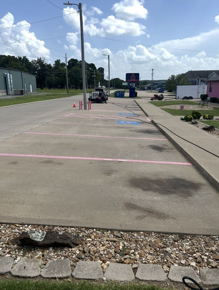 Commercial parking lot concrete with dark stains, before pressure washing